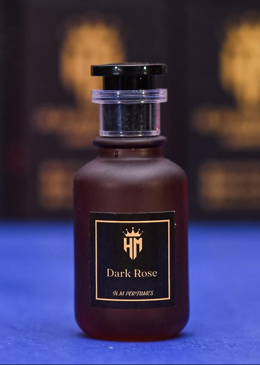 Dark Rose perfume bottle with a black and gold label on a blue background